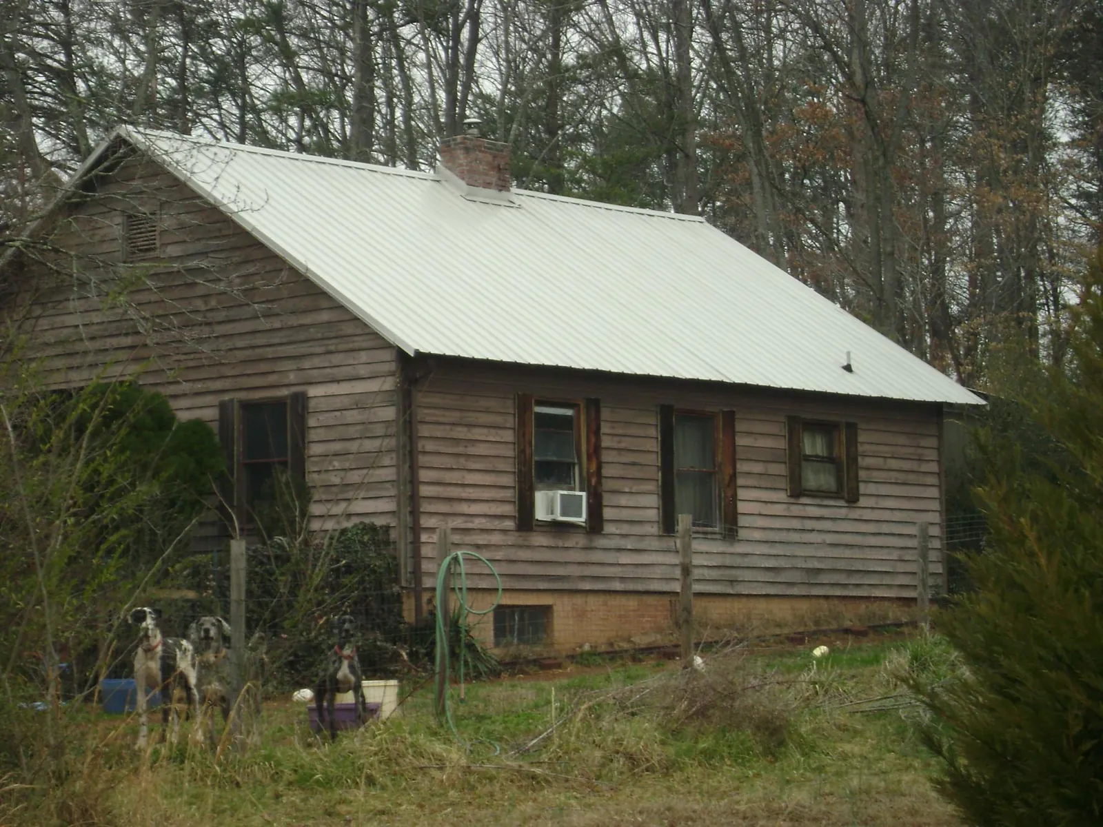 White metal roof on an old wood sided farmhouse, from a Metal Roof Installation job in Margaretville